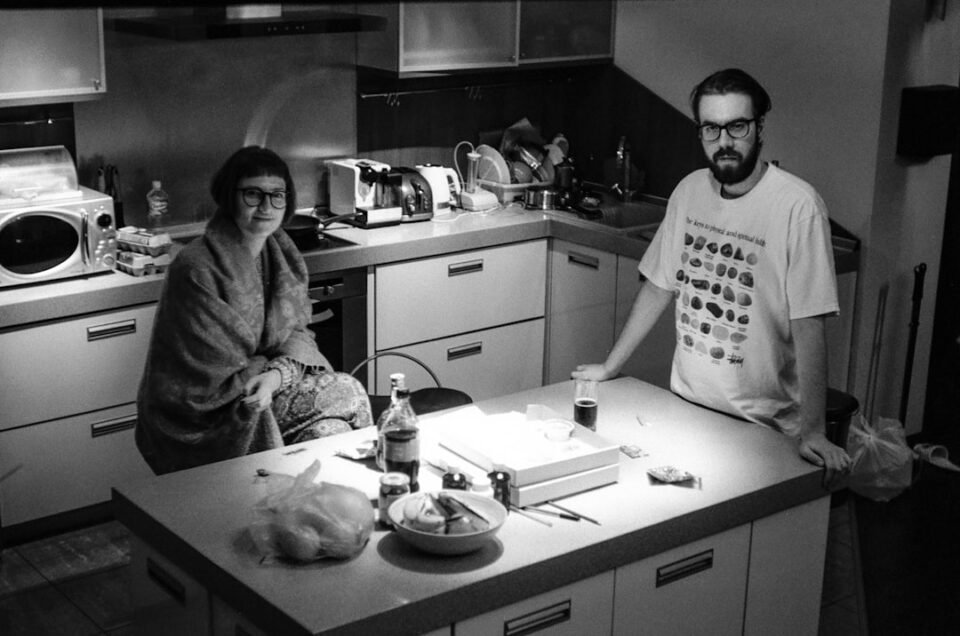 Family Education At Home illustration of a parent and child reading together around a kitchen table